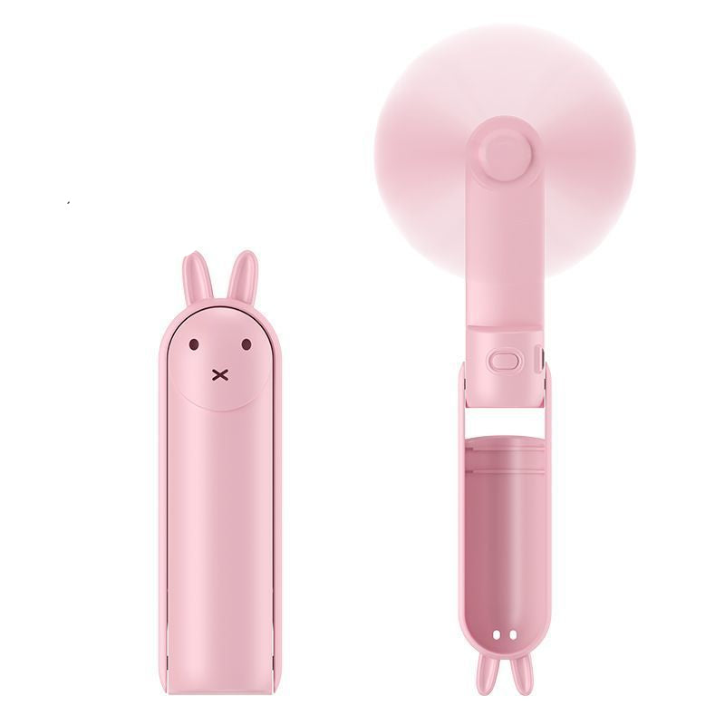 Pink handheld fan with cartoon design on a white background